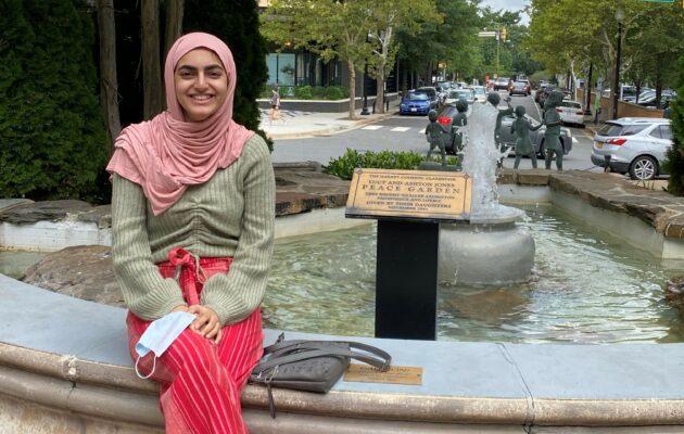 Amna sitting beside a fountain