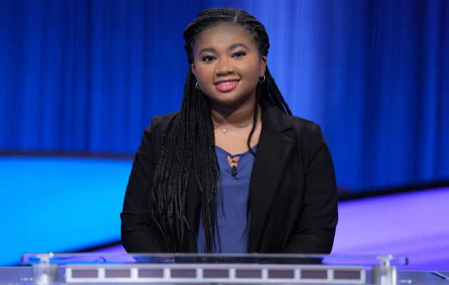 Maya at the the podium on the set of Jeopardy!