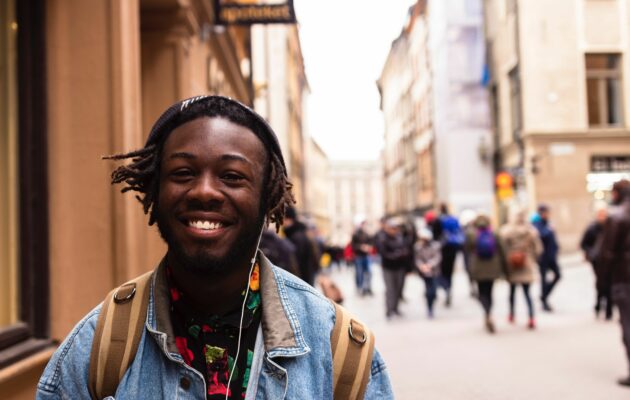 Smiling young man in a busy street